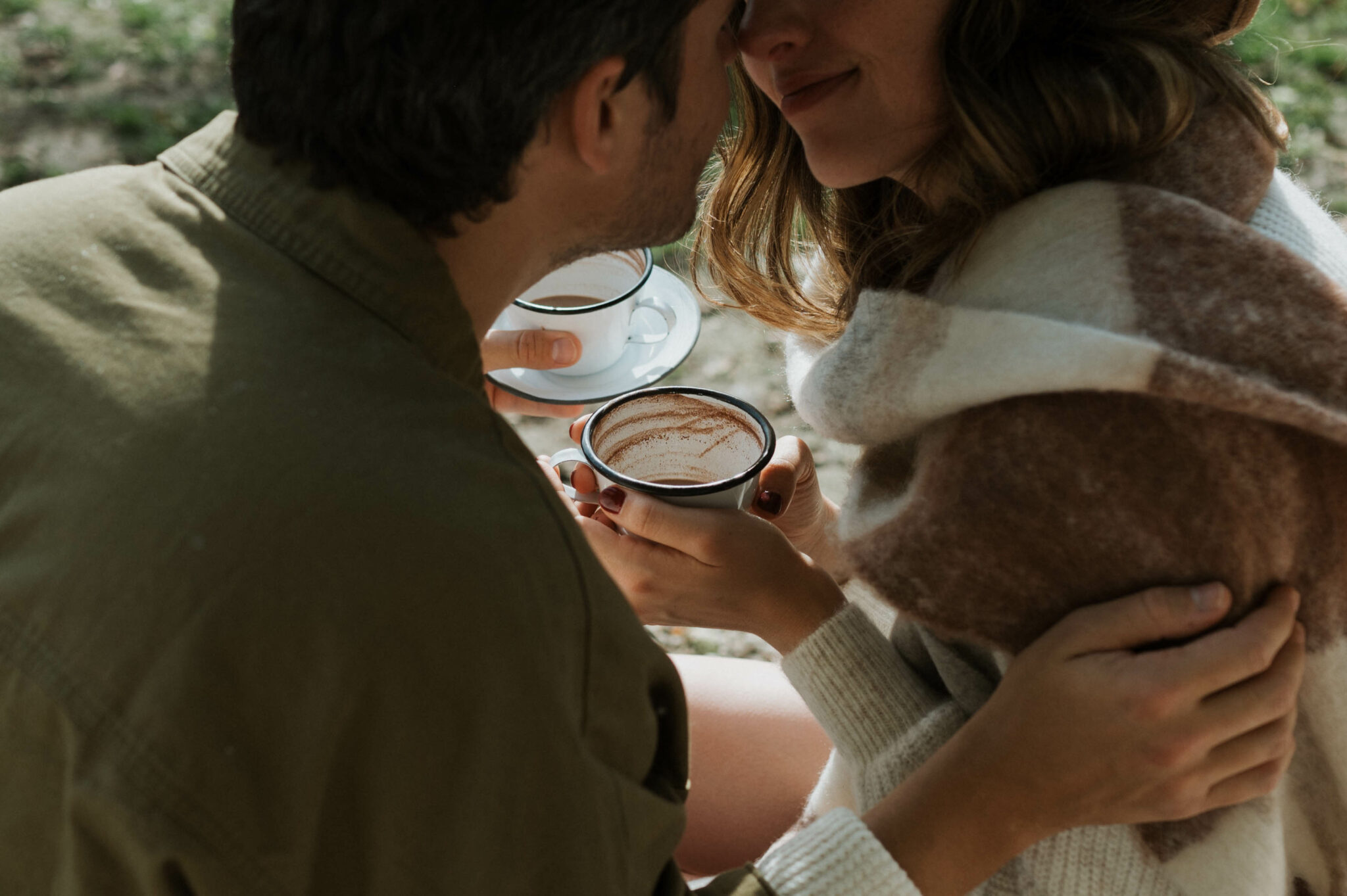 Une séance photo de couple cocooning avec une tasse de chocolat chaud à la main